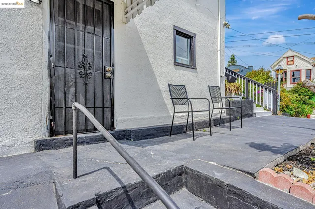 a view of a patio with a table and chairs