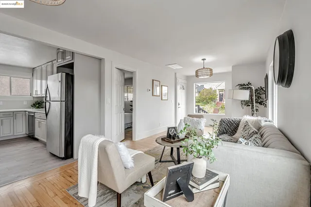 a living room with furniture and a kitchen