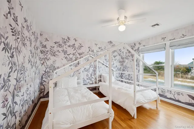 a spacious bedroom with a bed and a chandelier