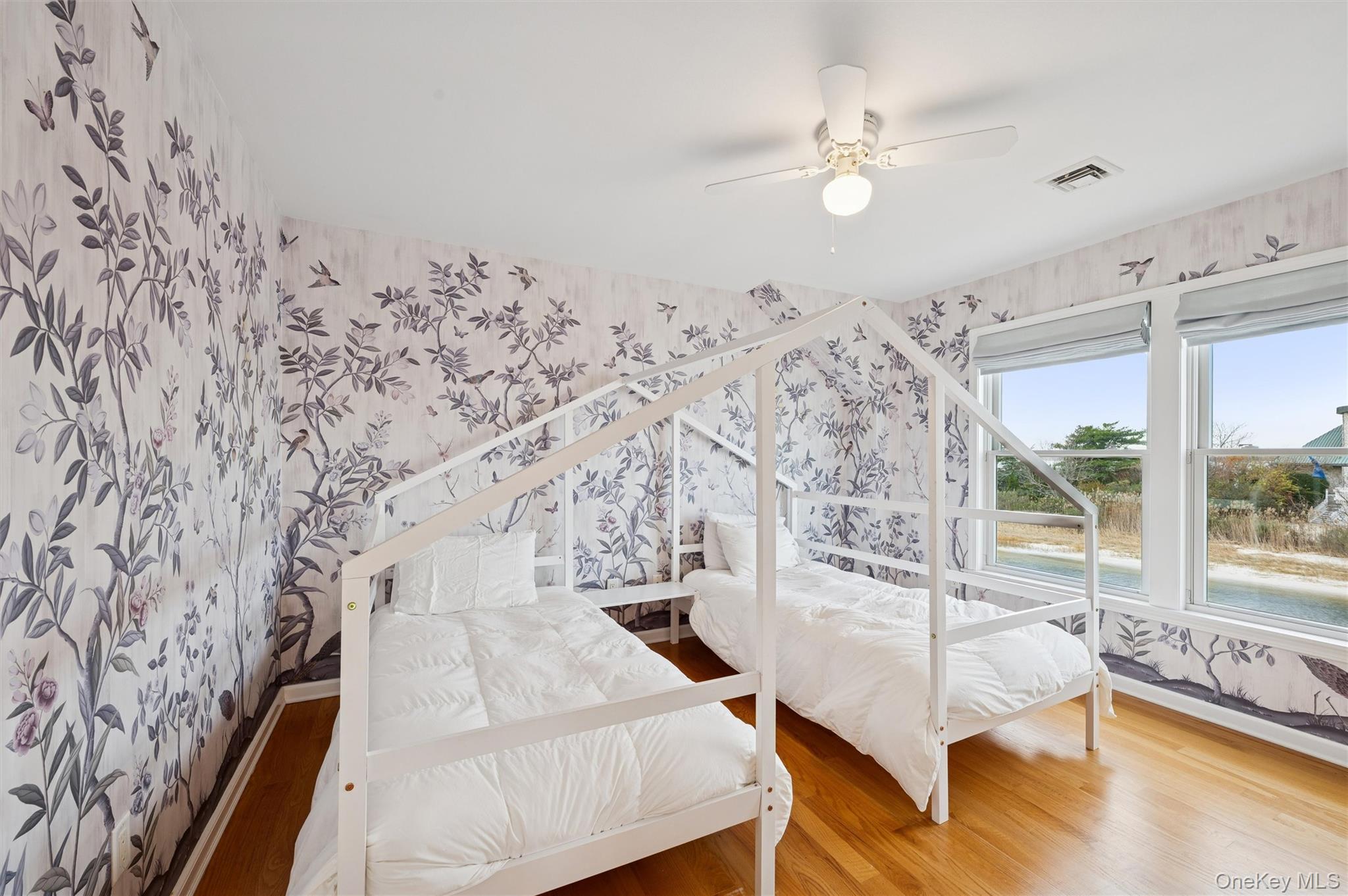 112 Pine Avenue Flanders, NY 11901 - Photo 14 of 29 a spacious bedroom with a bed and a chandelier