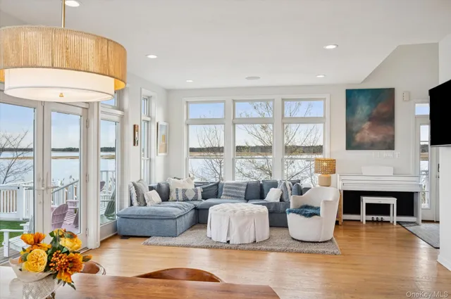 a living room with fireplace furniture and a large window