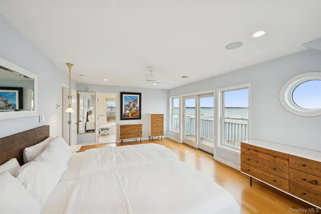 a spacious bedroom with a large bed and a large window