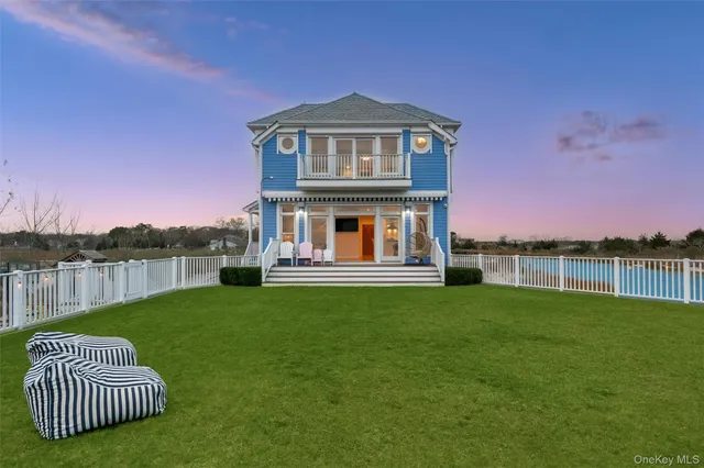 a front view of a house with a garden and a swimming pool