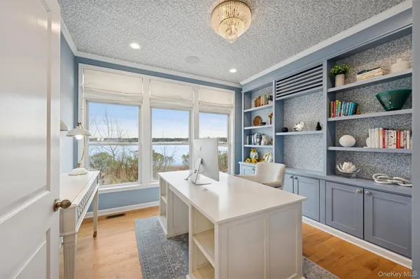a large kitchen with kitchen island a large window a sink and a counter space
