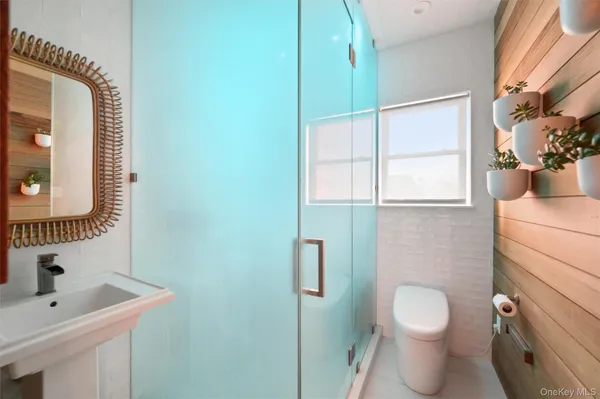 a bathroom with a toilet sink vanity and mirror