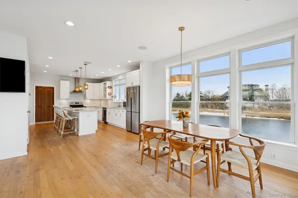 a open kitchen with white cabinets and stainless steel appliances