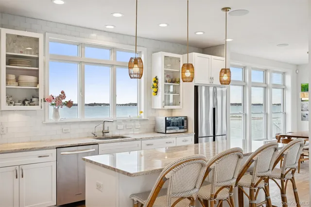 a kitchen with stainless steel appliances granite countertop a kitchen island a stove and a cabinets with wooden floor