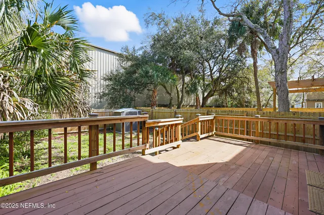 a view of balcony with wooden floor and fence