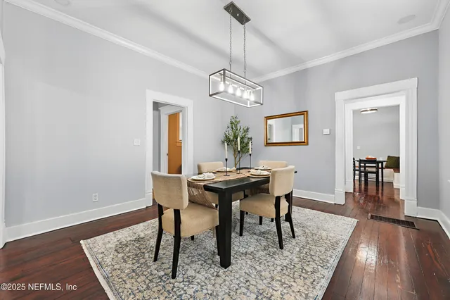 a view of a dining room with furniture wooden floor and a rug