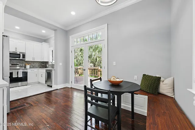 a open dining room with furniture and wooden floor