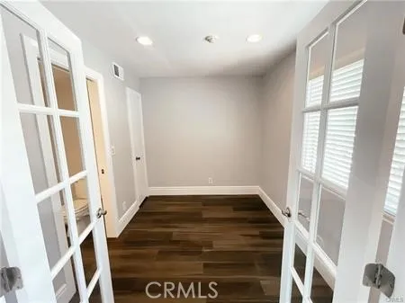 a view of an empty room with window and fire place