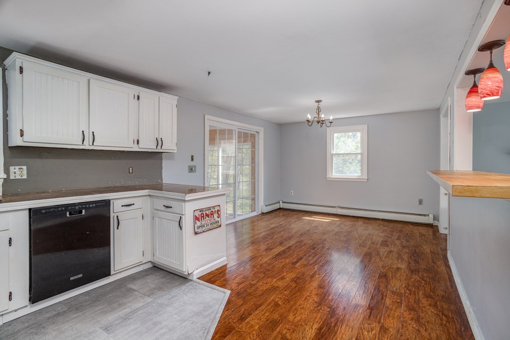1 Needham Road Westminster, MA 01473 - Photo 12 of 42 a kitchen with granite countertop a stove and white cabinets