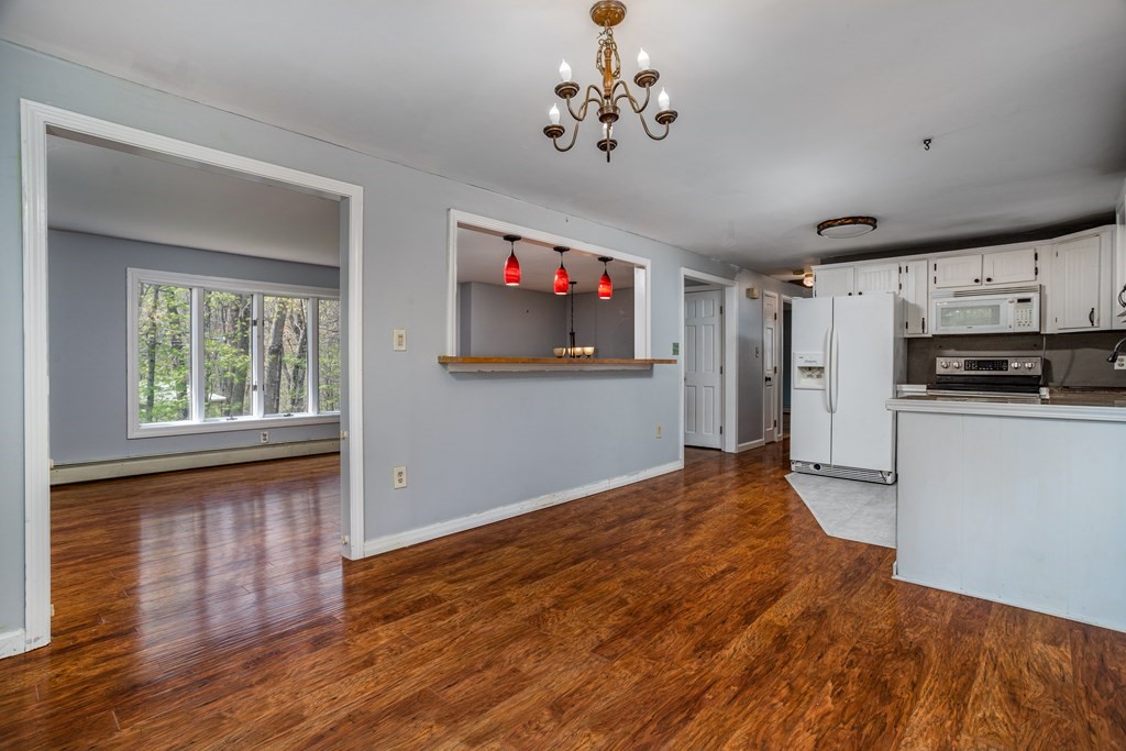 1 Needham Road Westminster, MA 01473 - Photo 13 of 42 a view of a kitchen with microwave and wooden floor