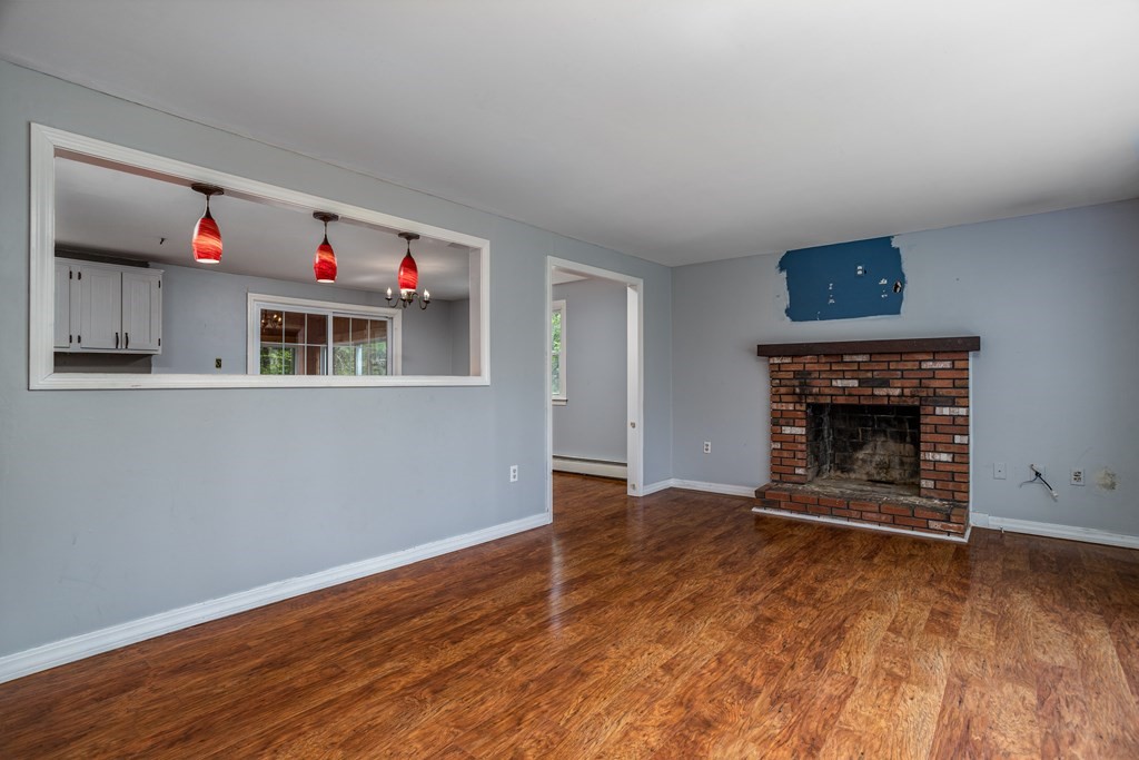 1 Needham Road Westminster, MA 01473 - Photo 16 of 42 a view of an empty room with wooden floor fireplace and a window