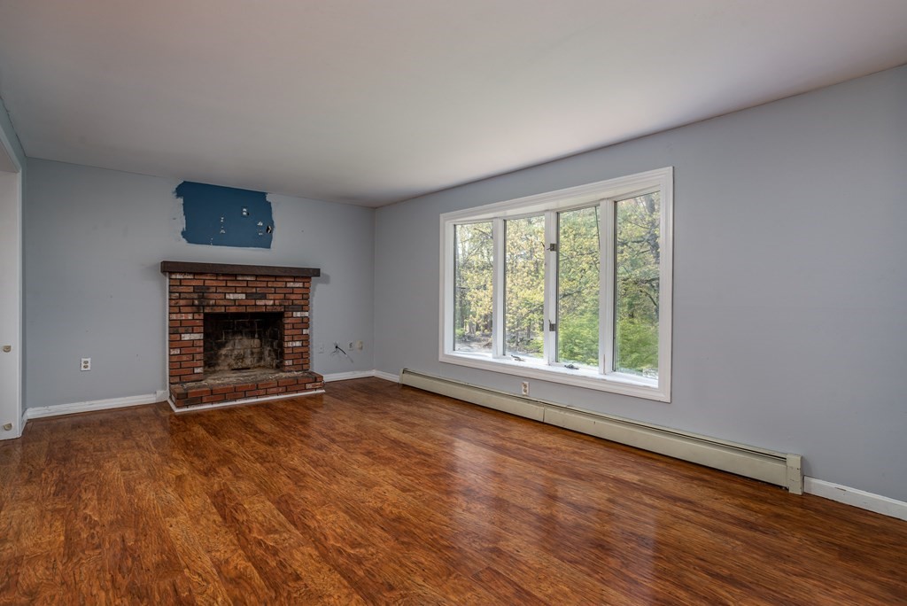 1 Needham Road Westminster, MA 01473 - Photo 17 of 42 an empty room with fireplace and windows
