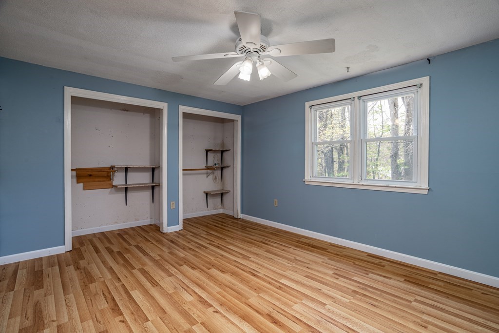 1 Needham Road Westminster, MA 01473 - Photo 20 of 42 a bedroom with a bed and a chandelier
