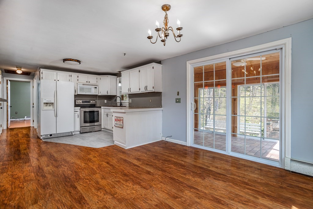 1 Needham Road Westminster, MA 01473 - Photo 3 of 42 a kitchen with stainless steel appliances wooden floor and white cabinets