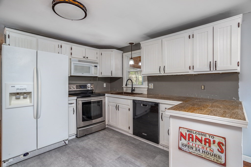 1 Needham Road Westminster, MA 01473 - Photo 10 of 42 a kitchen with stainless steel appliances granite countertop a stove a sink and a refrigerator