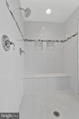 a bathroom with a granite countertop toilet sink and mirror