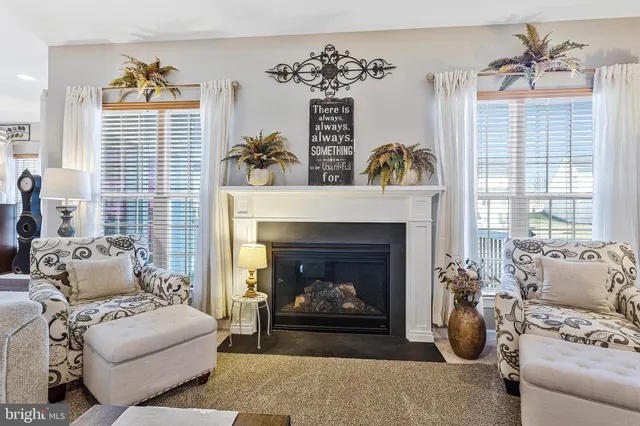 a kitchen with stainless steel appliances kitchen island granite countertop a table chairs and a refrigerator