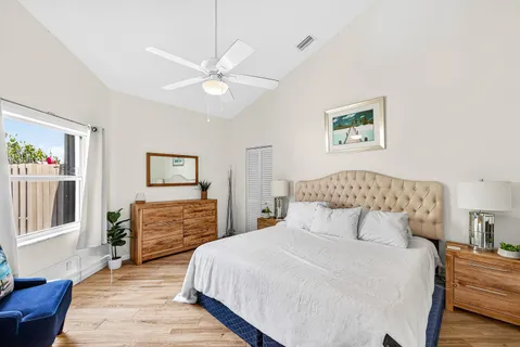 a bedroom with a large bed and a chandelier