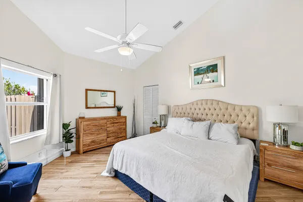 a bedroom with a large bed and a chandelier