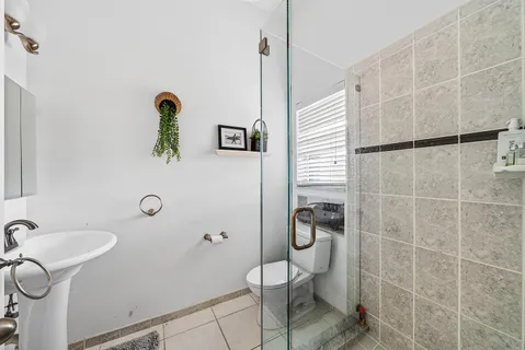 a bathroom with a shower and a sink