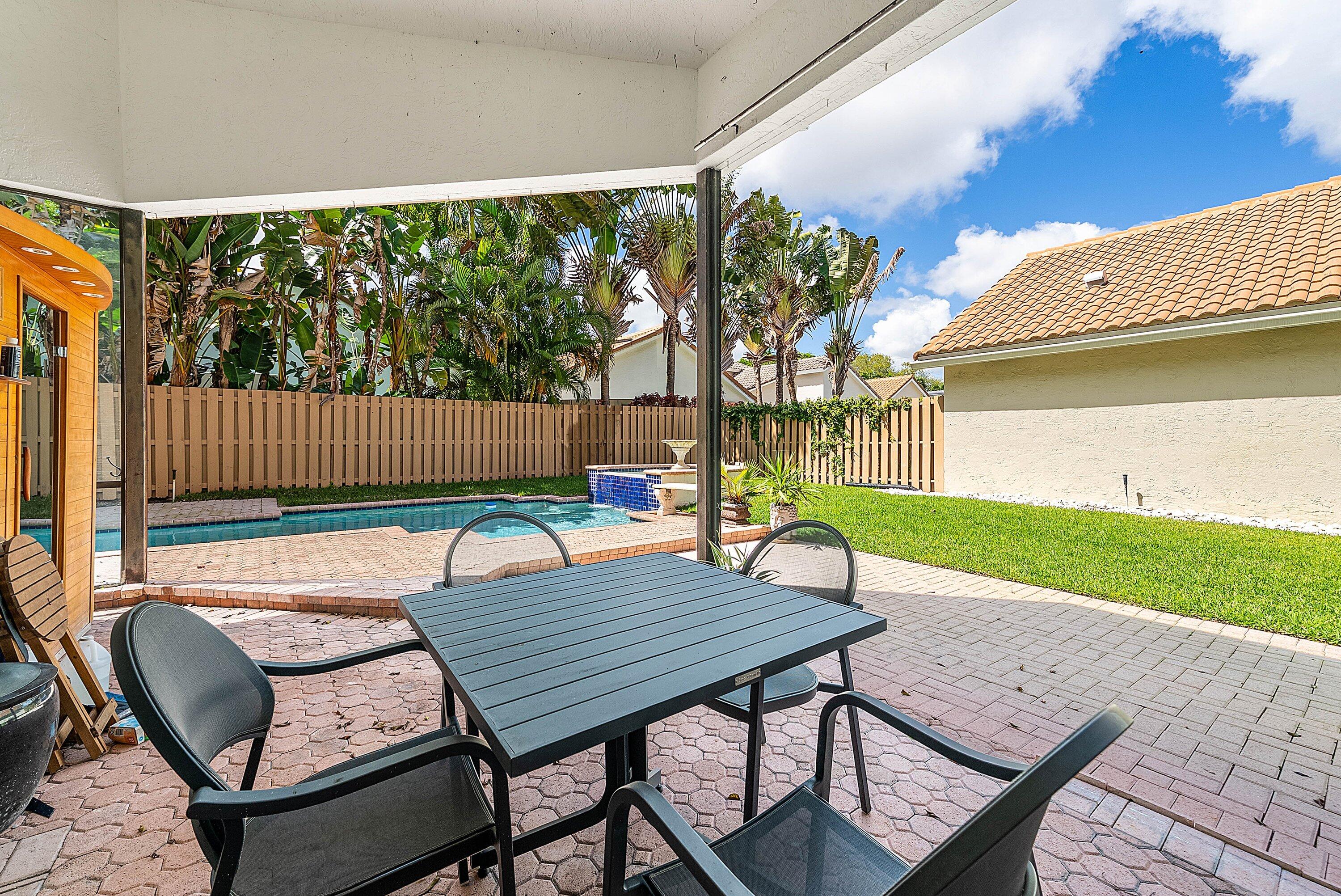 6601 Northwest 26th Way Boca Raton, FL 33496 - Photo 19 of 26 a view of a wooden chairs and table in the patio