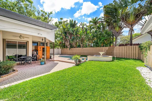 a view of a patio with chairs and a yard