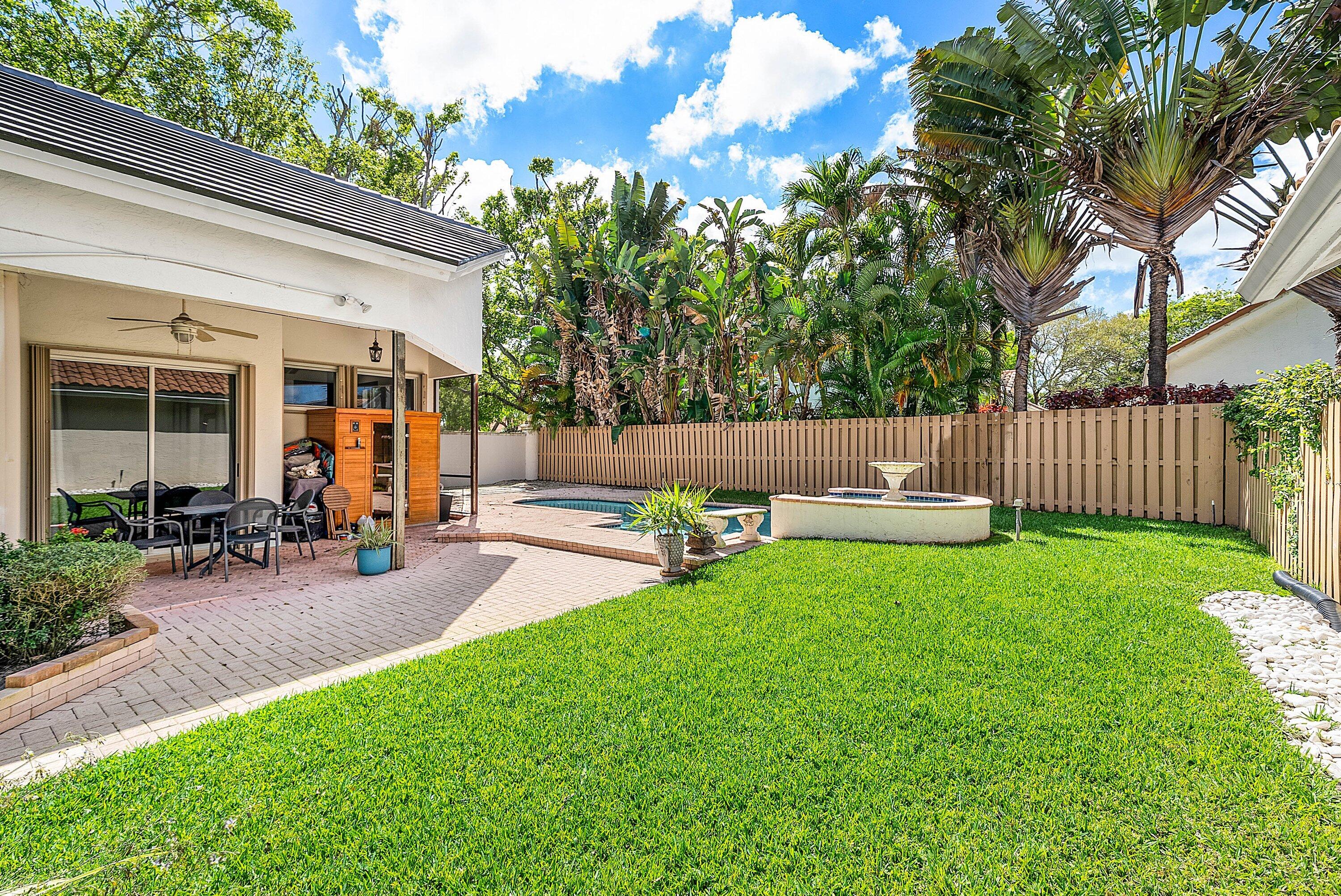 6601 Northwest 26th Way Boca Raton, FL 33496 - Photo 20 of 26 a view of a patio with chairs and a yard