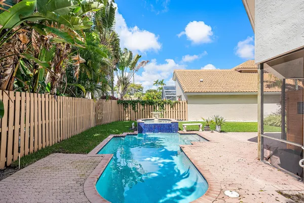 a view of a backyard with a garden and entertaining space