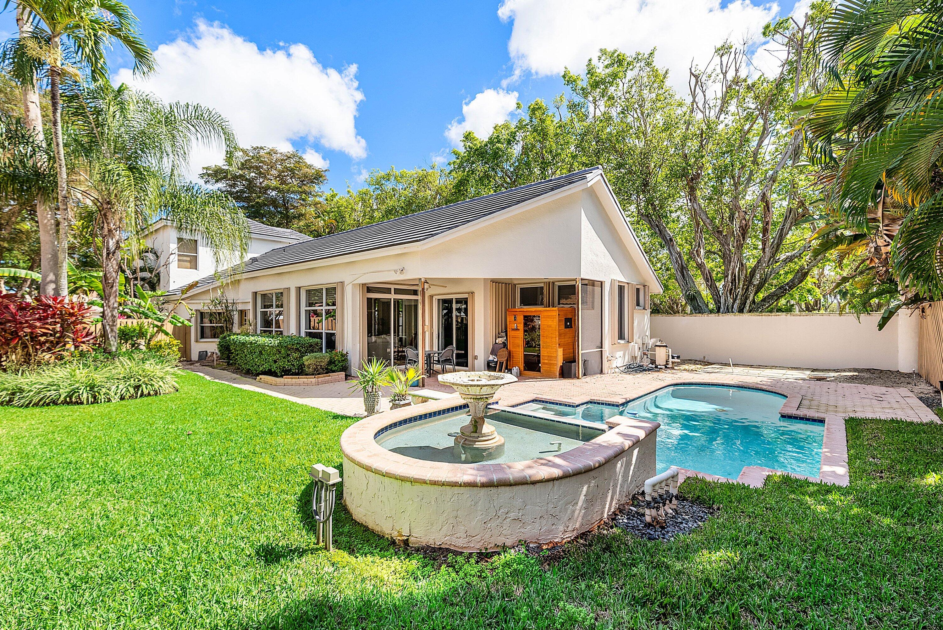 6601 Northwest 26th Way Boca Raton, FL 33496 - Photo 22 of 26 a front view of house with yard and outdoor seating