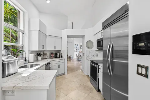 a large kitchen with a refrigerator sink and microwave
