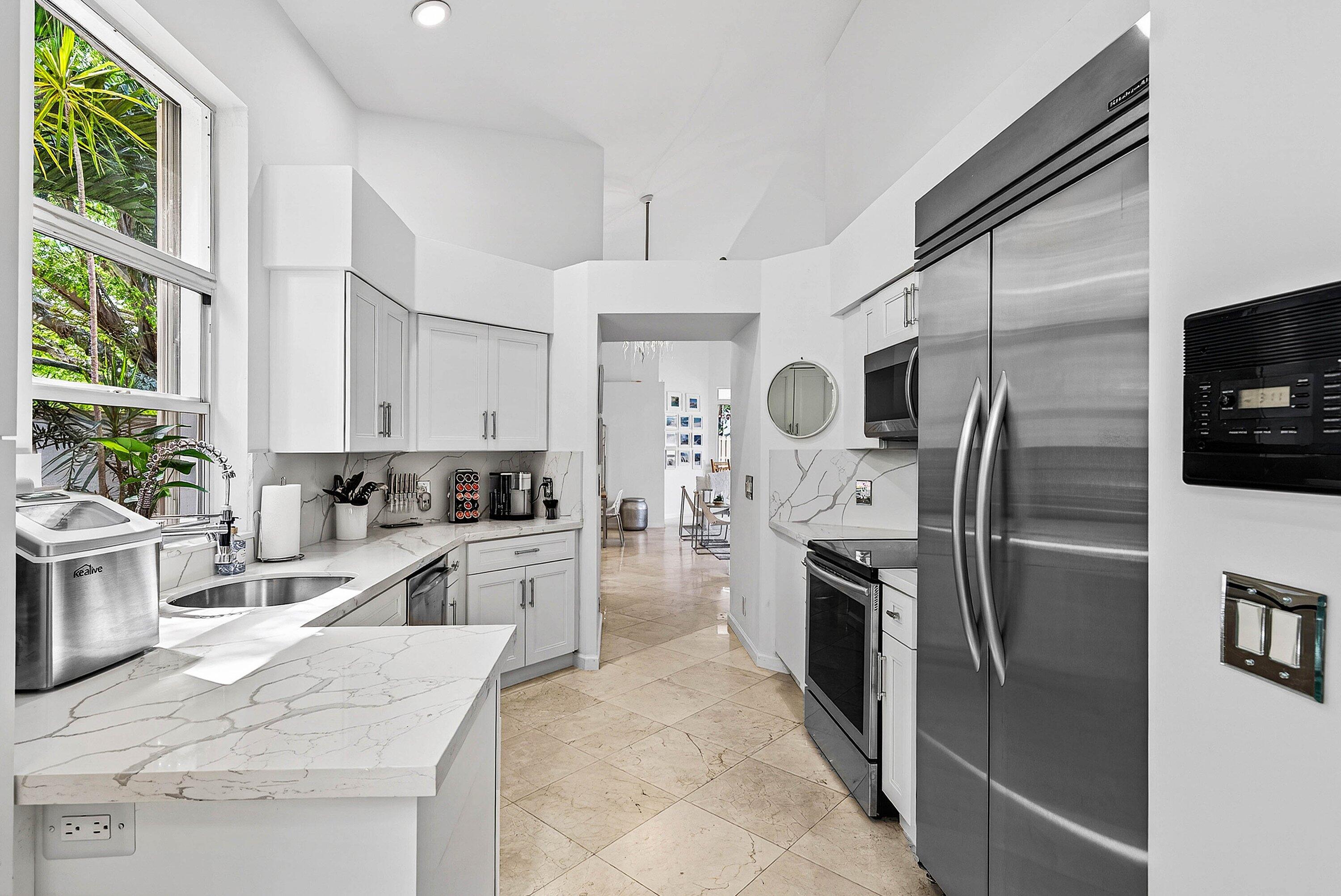 6601 Northwest 26th Way Boca Raton, FL 33496 - Photo 7 of 26 a large kitchen with a refrigerator sink and microwave