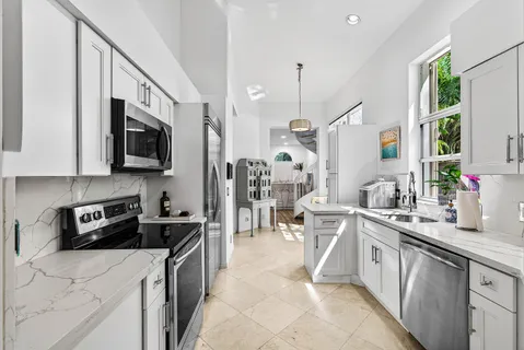 a kitchen that has a lot of cabinets in it and appliances