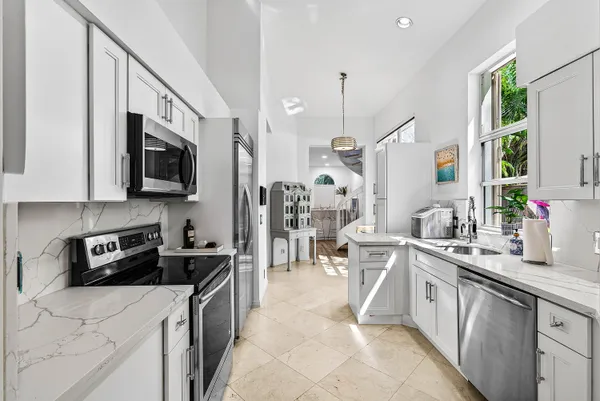 a kitchen that has a lot of cabinets in it and appliances