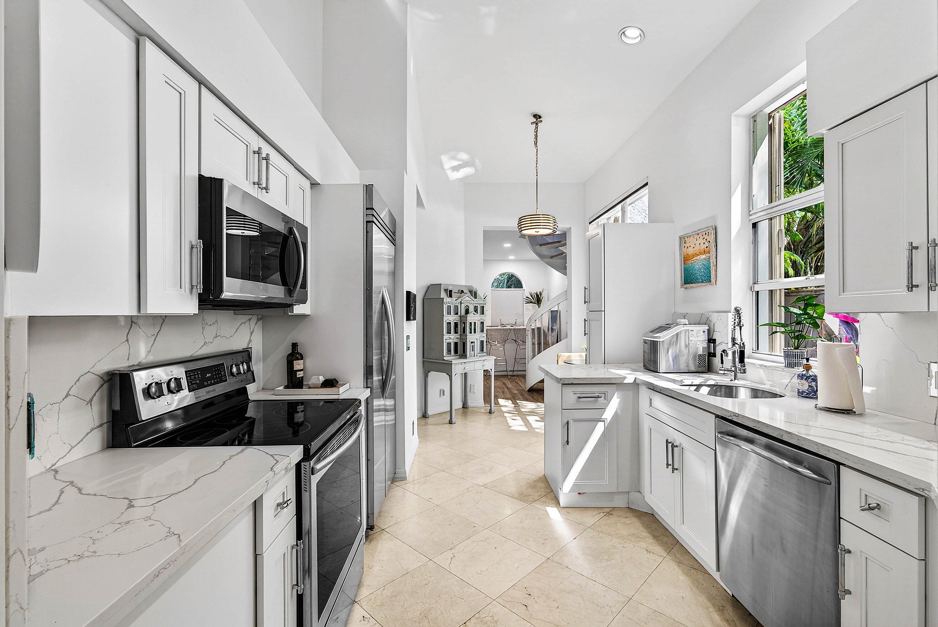6601 Northwest 26th Way Boca Raton, FL 33496 - Photo 8 of 26 a kitchen that has a lot of cabinets in it and appliances