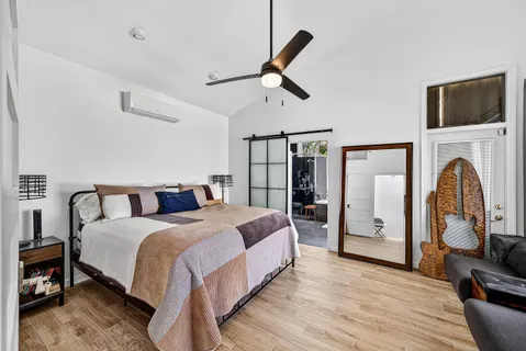 a bed room with a bed and a chandelier