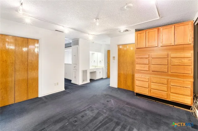 a view of a kitchen with cabinets and wooden floor