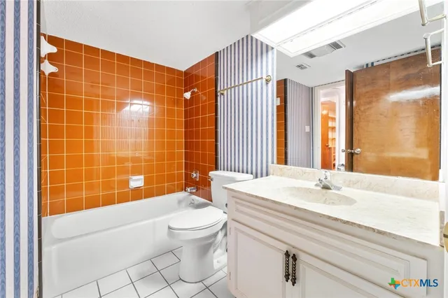 a bedroom with furniture and large windows