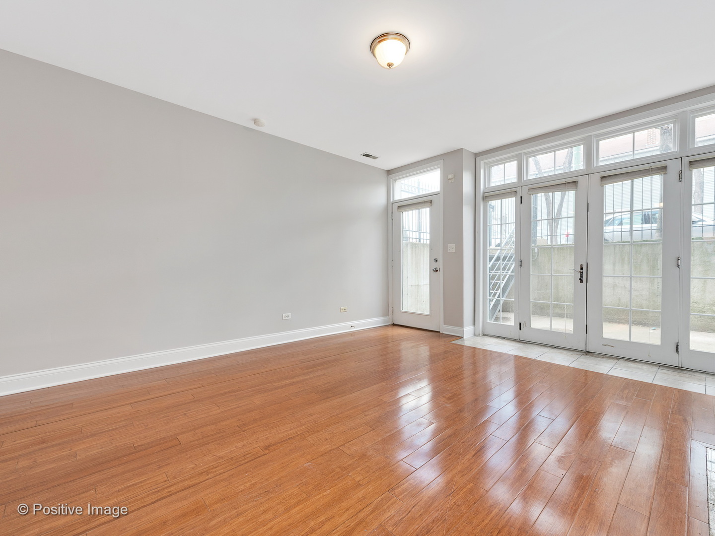 526 North May Street, Unit 1 Chicago, IL 60642 - Photo 4 of 15 wooden floor in an empty room with a window