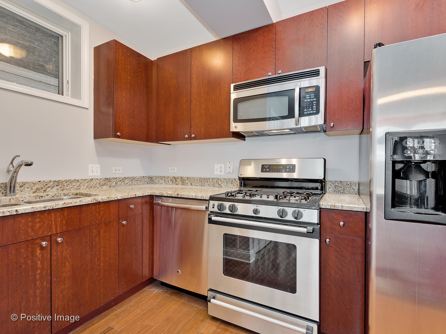 526 North May Street, Unit 1 Chicago, IL 60642 - Photo 6 of 15 a kitchen with stainless steel appliances granite countertop a stove microwave and sink