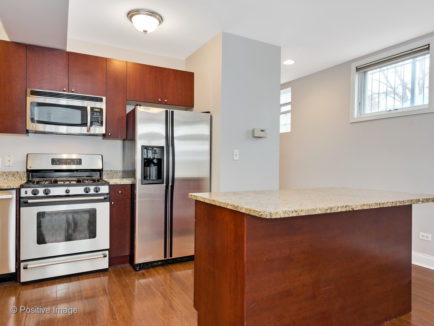 526 North May Street, Unit 1 Chicago, IL 60642 - Photo 8 of 15 a kitchen with stainless steel appliances granite countertop a refrigerator a stove a sink and a microwave