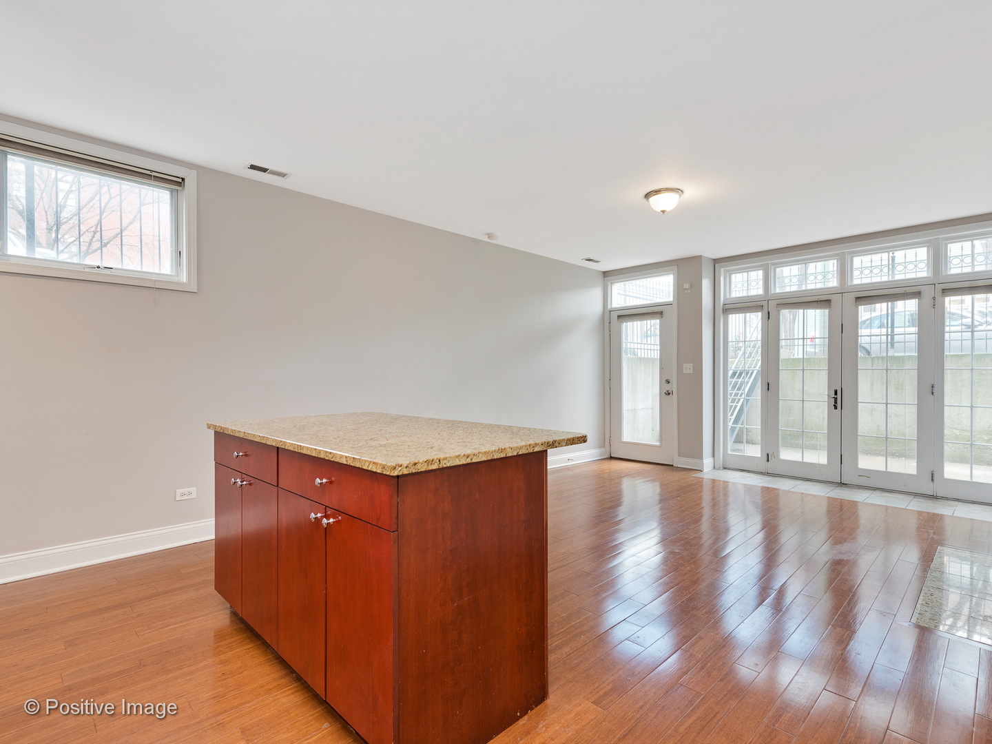 526 North May Street, Unit 1 Chicago, IL 60642 - Photo 9 of 15 a view of an empty room with wooden floor and a window