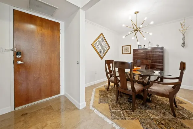 a view of a dining room with furniture and chandelier
