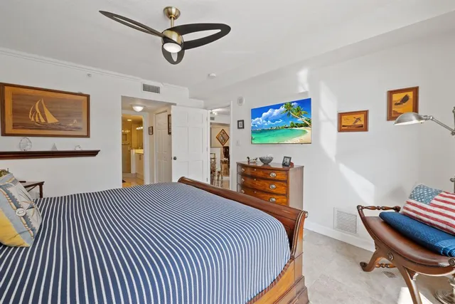 a bedroom with furniture and a ceiling fan