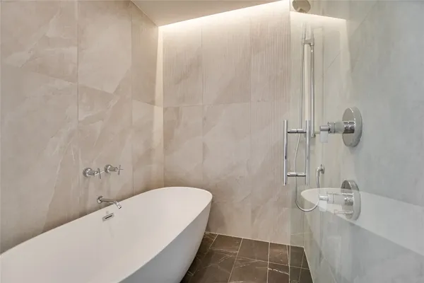 a bathroom with a bathtub and shower