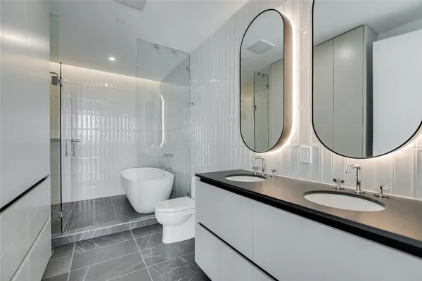 a bathroom with a toilet a sink and a mirror