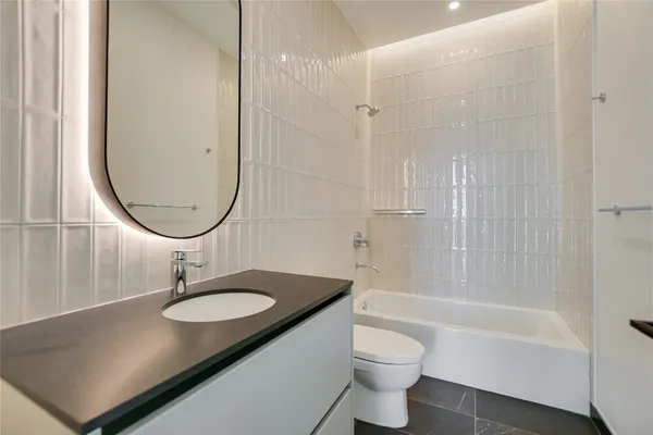 a bathroom with a sink a toilet and a mirror