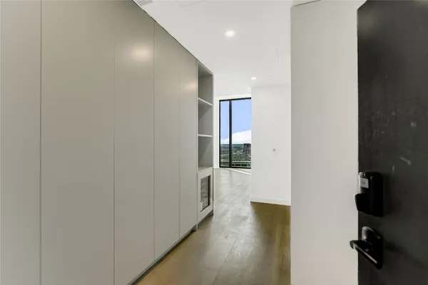 a view of a hallway with wooden floor